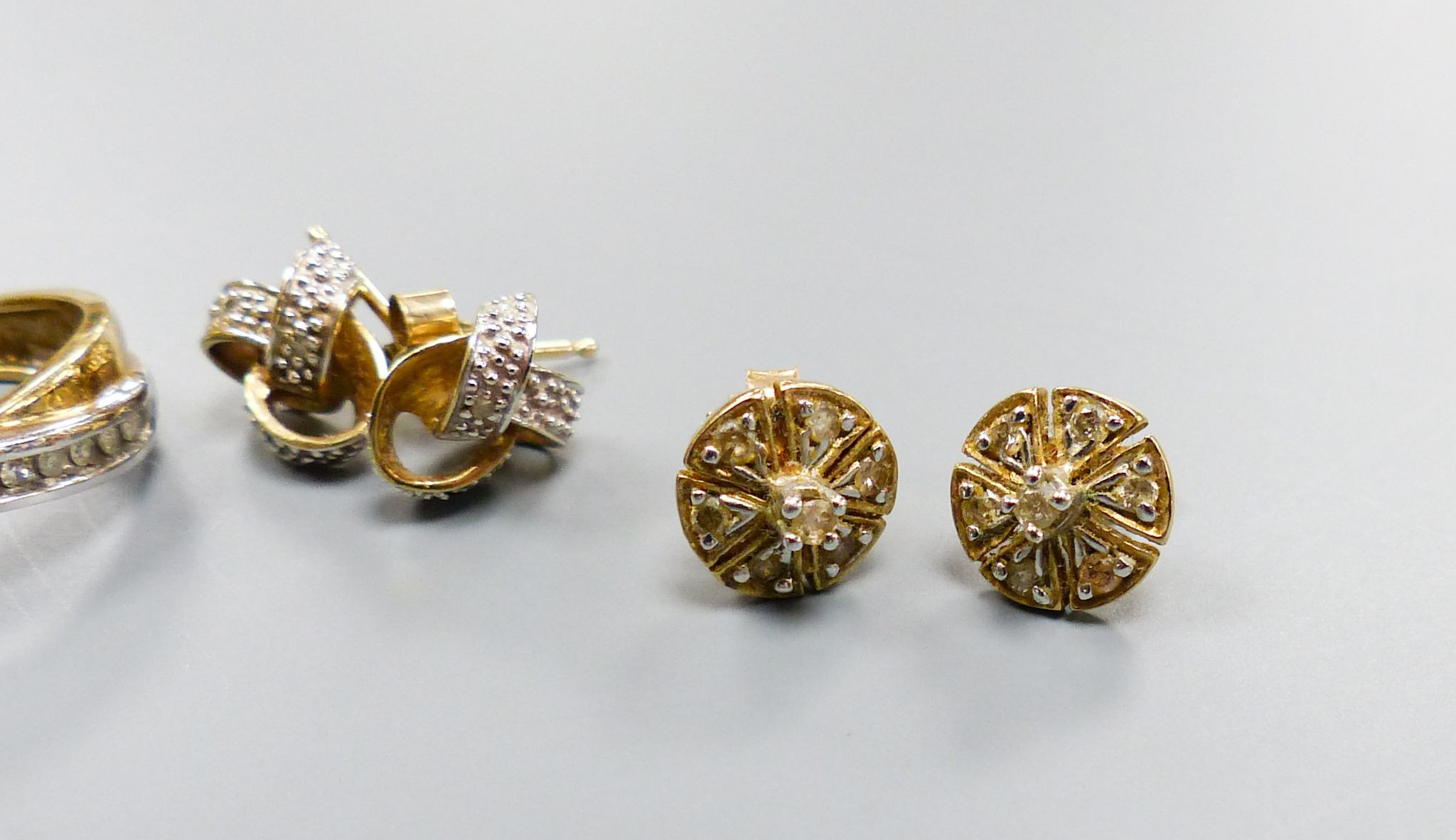 Four assorted modern pairs of 9ct and diamond chip set earrings, largest 18mm, gross weight 8.4 grams.